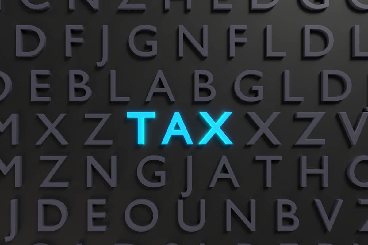 The word tax is spelled out on a black background.