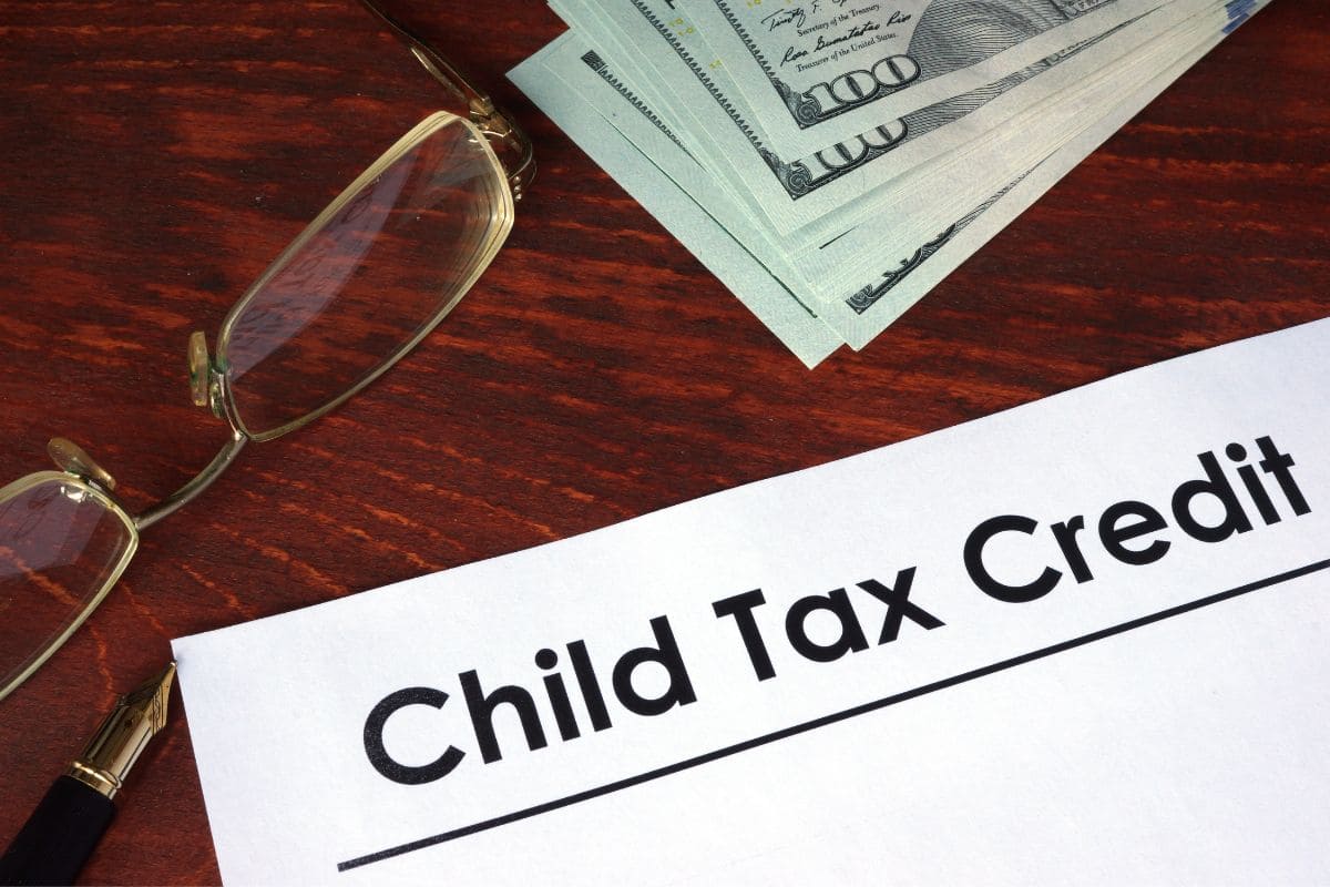 A child tax credit is sitting on top of a pile of money.